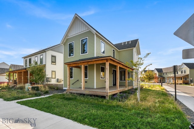 farmhouse inspired home featuring a front yard and covered porch