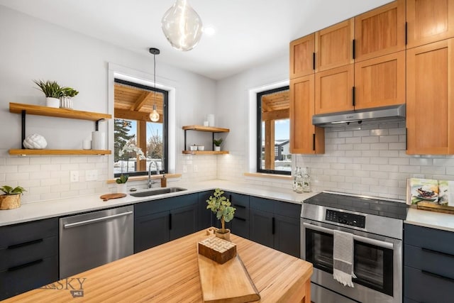 kitchen featuring sink, dishwasher, pendant lighting, wall oven, and decorative backsplash