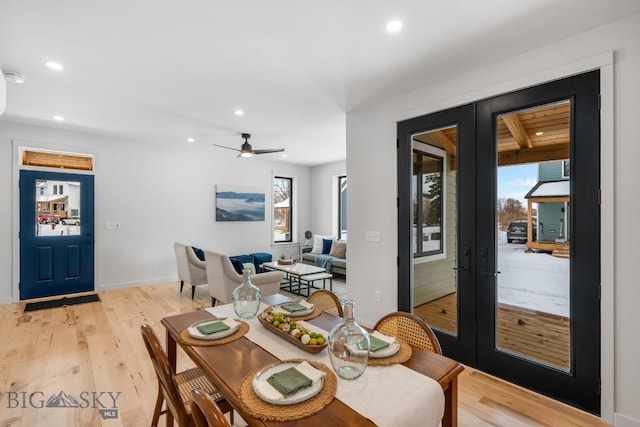 dining area with ceiling fan, a healthy amount of sunlight, light wood-type flooring, and french doors