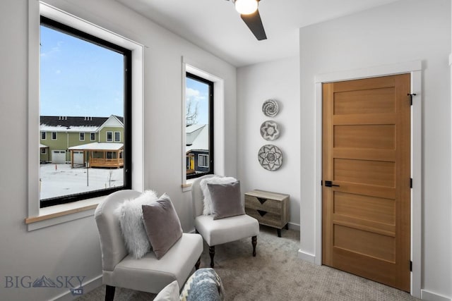 living area featuring ceiling fan and carpet floors