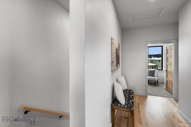 hallway with light hardwood / wood-style floors