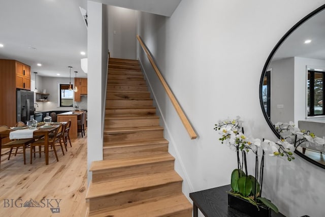 stairs featuring wood-type flooring