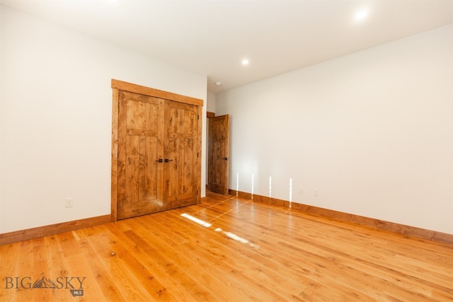 unfurnished room with wood-type flooring