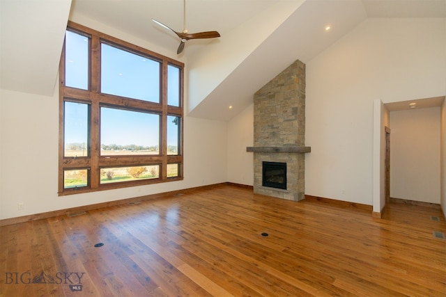 unfurnished living room with hardwood / wood-style floors, high vaulted ceiling, and a wealth of natural light