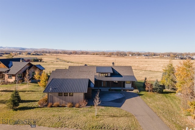 birds eye view of property with a rural view