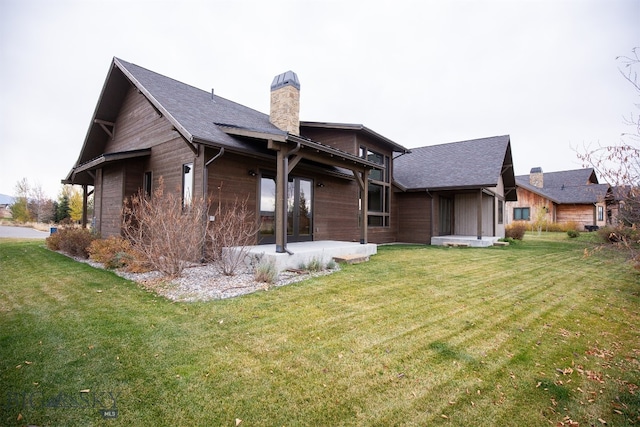 back of house featuring a patio and a lawn