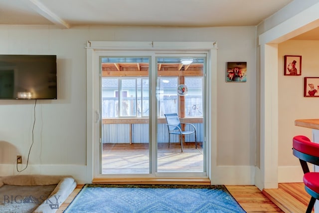 doorway to outside with wood-type flooring