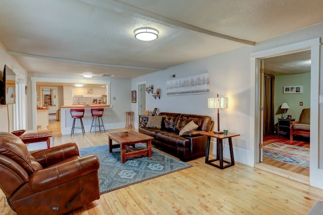 living room featuring a textured ceiling and light hardwood / wood-style flooring