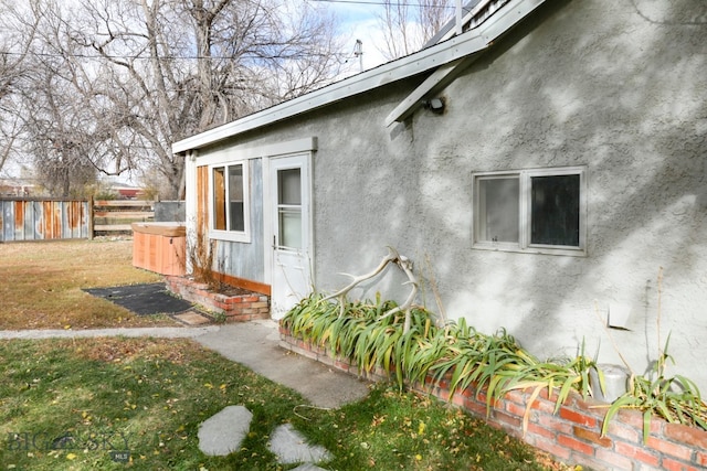 view of side of home with a hot tub