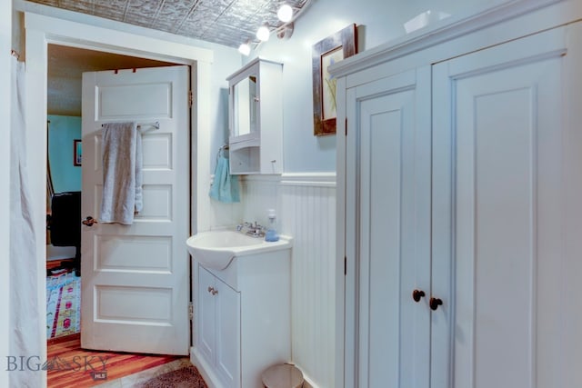 bathroom with hardwood / wood-style floors and vanity