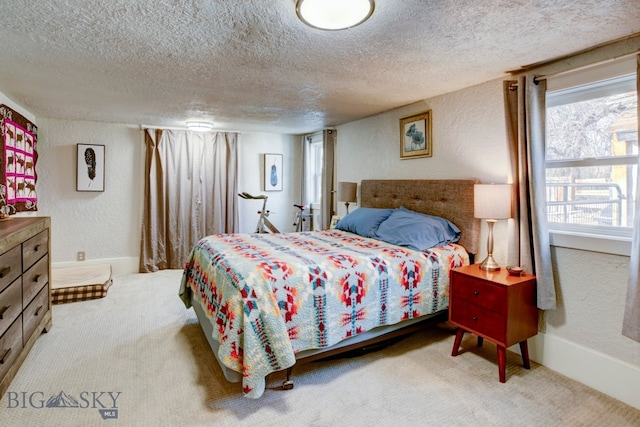 bedroom featuring carpet flooring and a textured ceiling