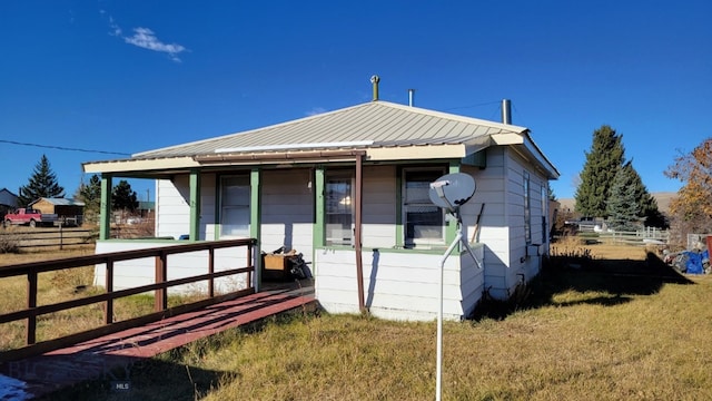 bungalow-style home with covered porch and a front yard