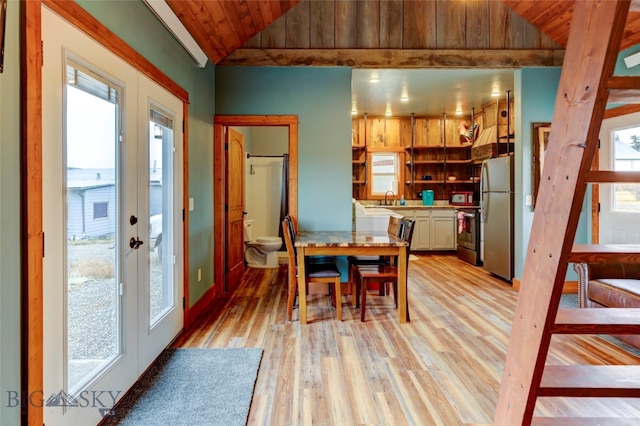 dining space with french doors, sink, wooden ceiling, light hardwood / wood-style floors, and lofted ceiling