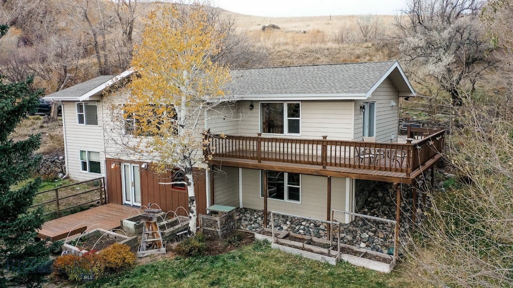 back of property with a wooden deck