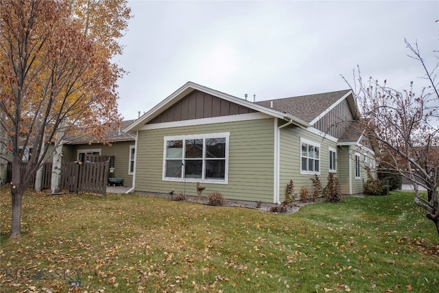 view of side of home with a lawn