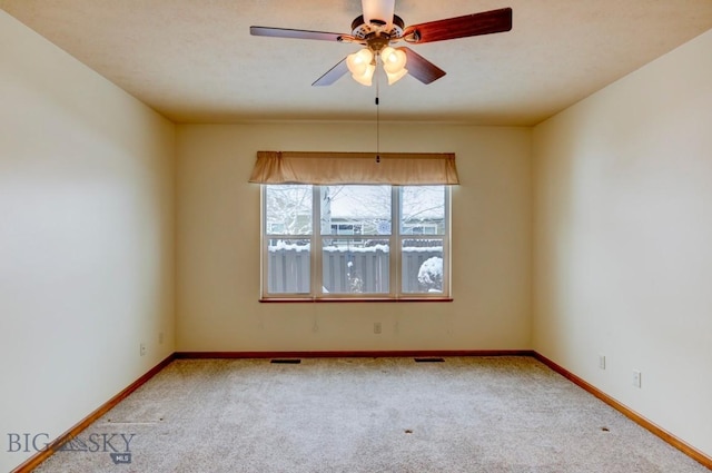 empty room with ceiling fan and carpet floors