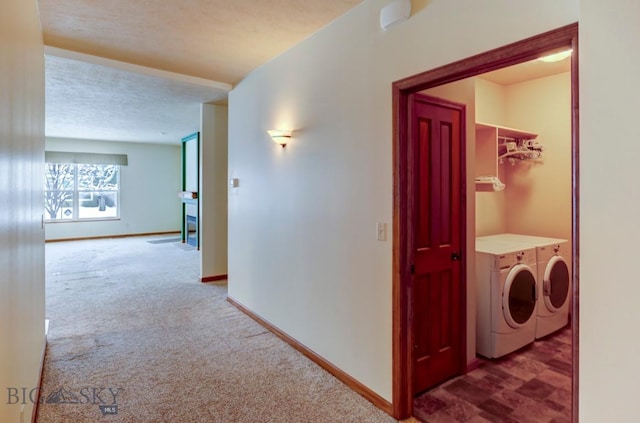 hall with carpet, a textured ceiling, and independent washer and dryer