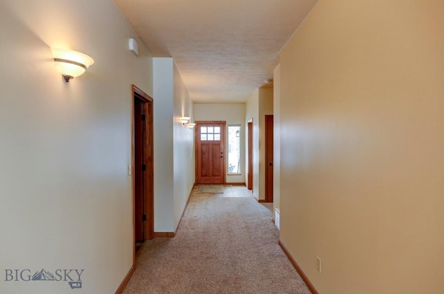 hallway with light colored carpet