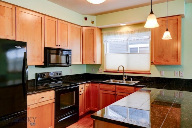 kitchen with hanging light fixtures, sink, and black appliances