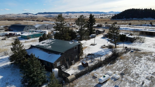 snowy aerial view featuring a mountain view