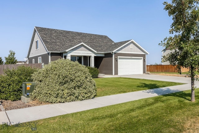 view of front of property with a garage and a front lawn