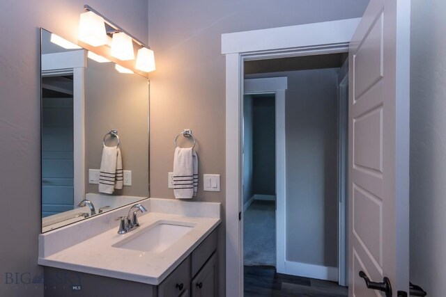 bathroom featuring hardwood / wood-style floors and vanity