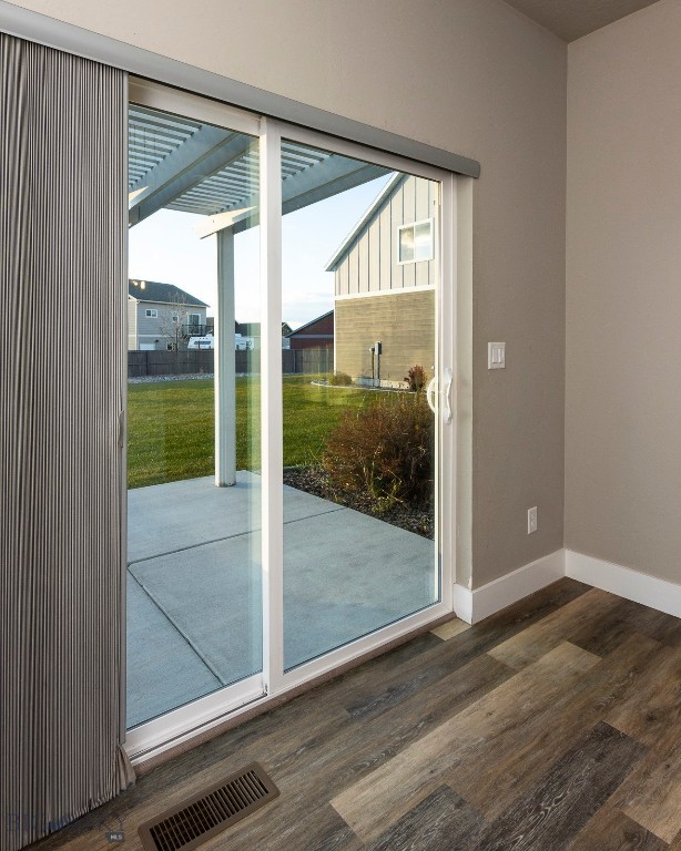 doorway to outside with dark hardwood / wood-style floors