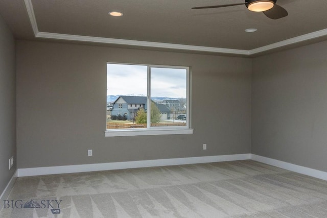 spare room featuring baseboards, light carpet, recessed lighting, a ceiling fan, and a raised ceiling