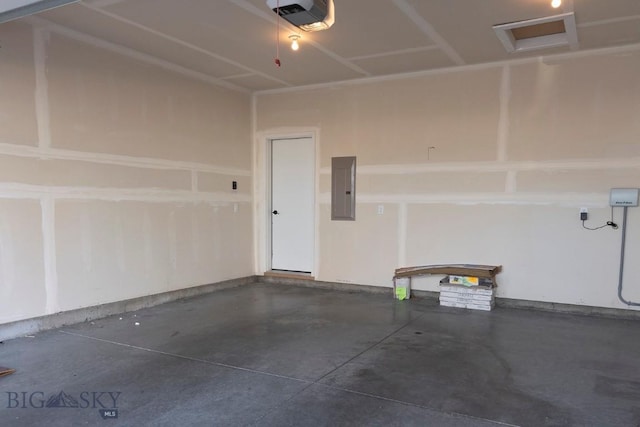 garage with a garage door opener and electric panel