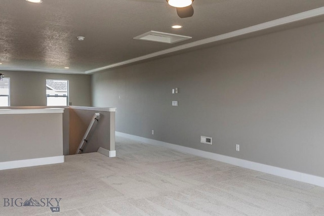 carpeted empty room featuring recessed lighting, visible vents, baseboards, and a textured ceiling