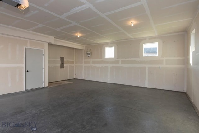 garage featuring a garage door opener and electric panel
