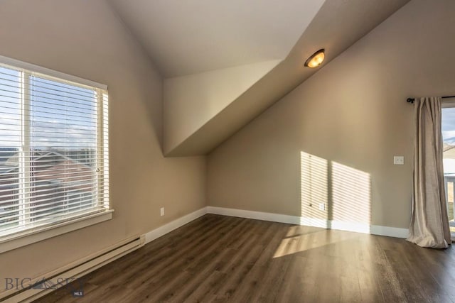 bonus room featuring a baseboard radiator, baseboards, dark wood-style floors, and vaulted ceiling