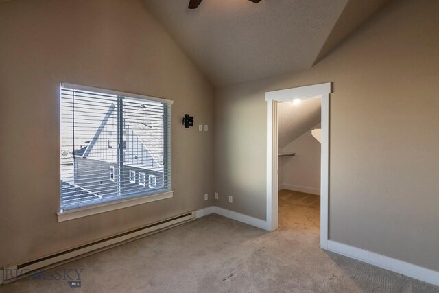 empty room with light carpet, a baseboard radiator, ceiling fan, and lofted ceiling