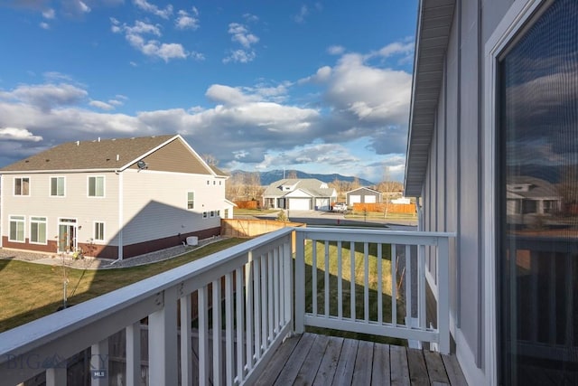 wooden terrace with a residential view and a mountain view