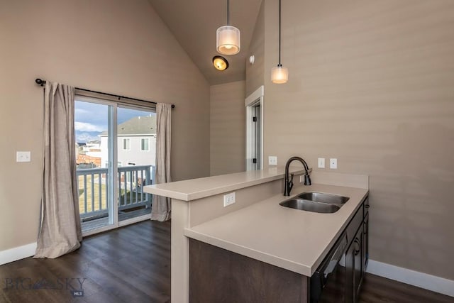 kitchen featuring a sink, light countertops, vaulted ceiling, and dark wood-style floors