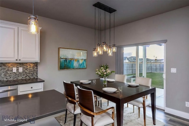 dining room with baseboards and wood finished floors