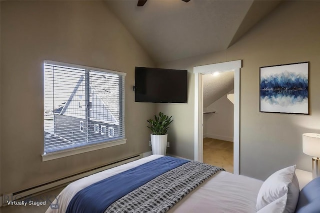 bedroom with carpet, a spacious closet, lofted ceiling, a baseboard radiator, and baseboards