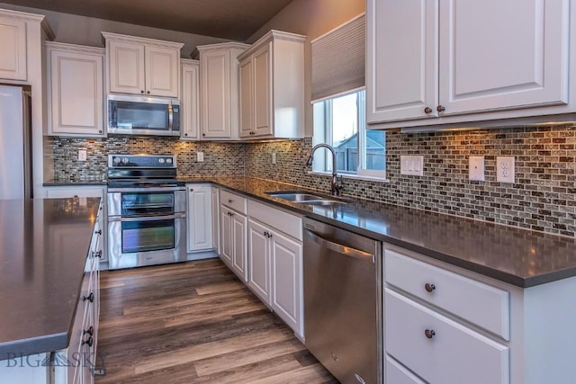 2133 Stewart Loop, Bozeman, MT 59718 - kitchen featuring stainless steel appliances, dark countertops, and white cabinets