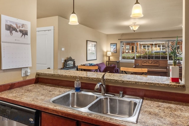 kitchen featuring dishwasher, hanging light fixtures, and sink