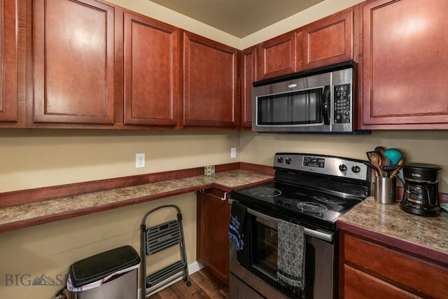 kitchen with dark hardwood / wood-style floors and appliances with stainless steel finishes