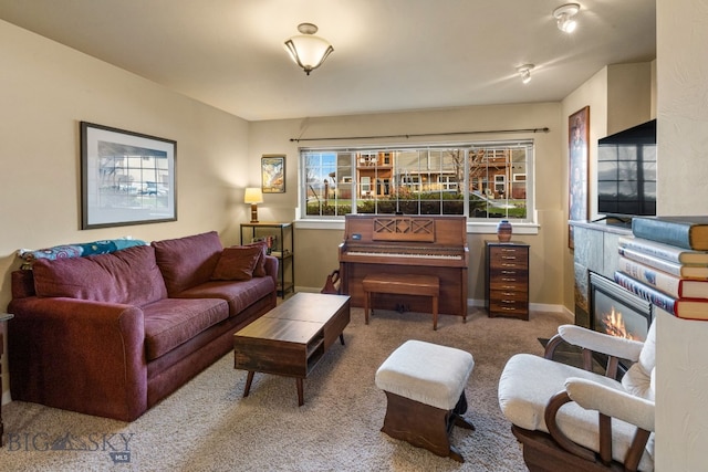 living room featuring carpet and a tiled fireplace