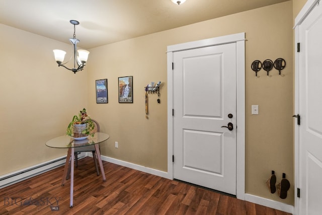 entrance foyer featuring dark hardwood / wood-style floors, an inviting chandelier, and a baseboard heating unit