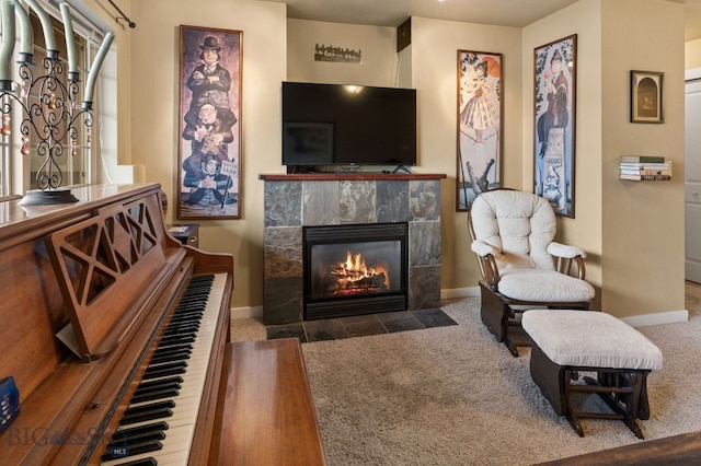 interior space with dark colored carpet and a tile fireplace