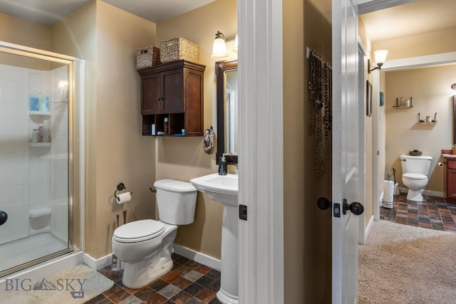 bathroom featuring toilet and walk in shower