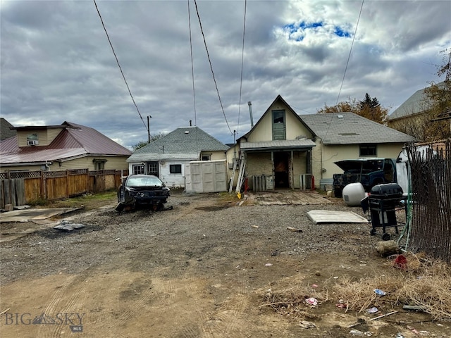 rear view of house featuring central AC unit