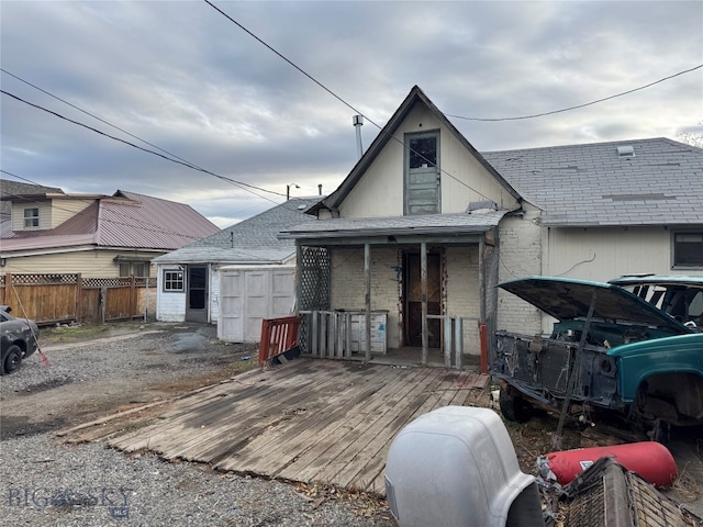 rear view of property featuring a deck