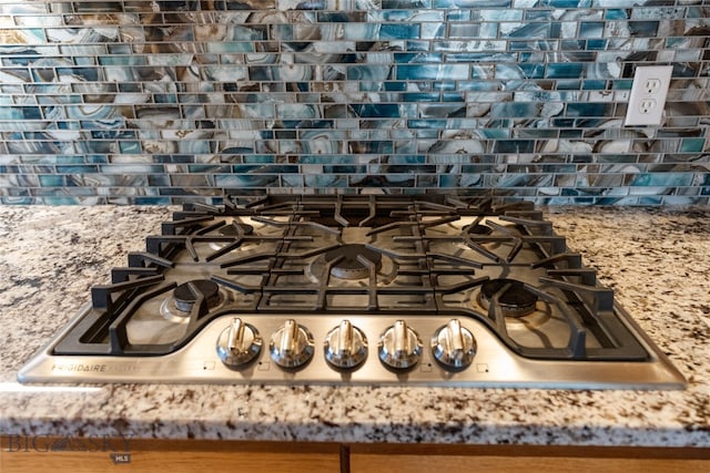 interior details with stone counters and stainless steel gas stovetop