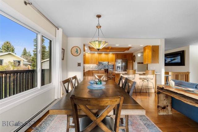 dining room with wood-type flooring and baseboard heating