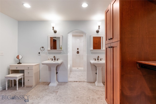 bathroom with a shower, tile patterned flooring, and tile walls