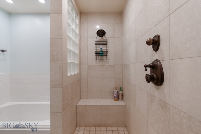 bathroom with shower with separate bathtub and tile patterned floors